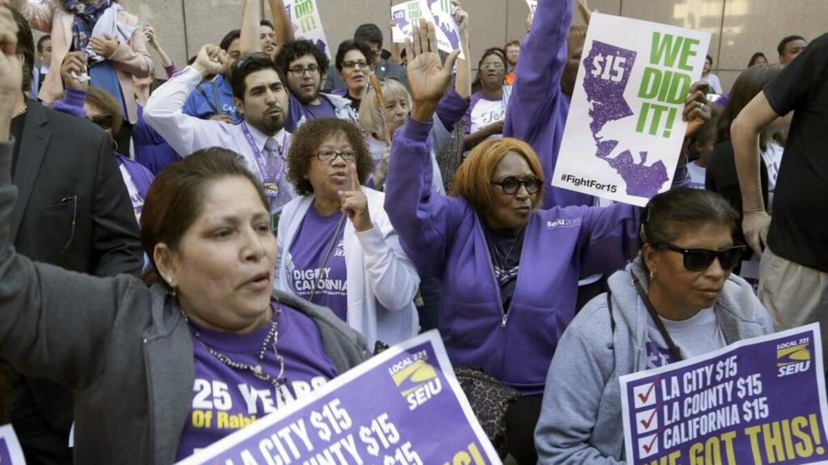 Workers rally outside the Ronald Reagan State Building in Los Angeles after Gov. Jerry Brown signed a bill creating the highest statewide minimum wage, $15 an hour, by 2022.