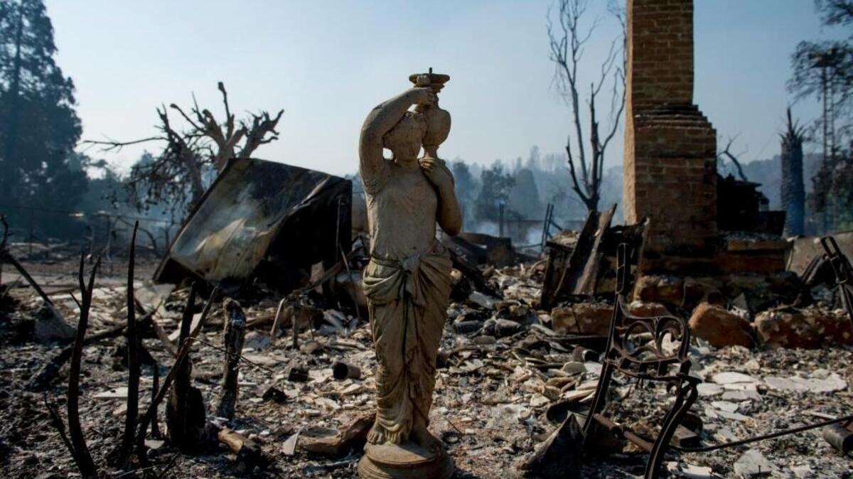 A small statue stands on scorched earth after the Clayton Fire passed through Lower Lake on Aug. 15.