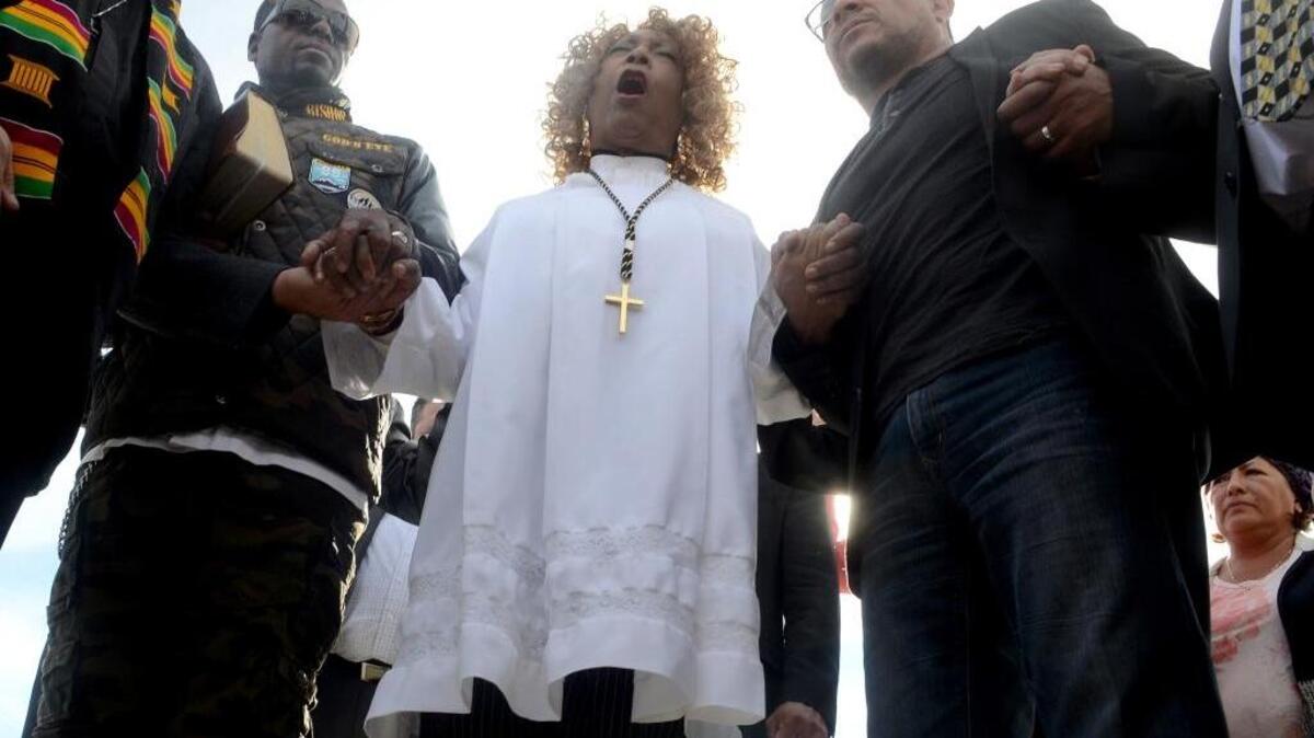 Jeannetta Million, center, of Victorious Believers Church leads a group of local pastors in a brief prayer vigil last week in San Bernardino.