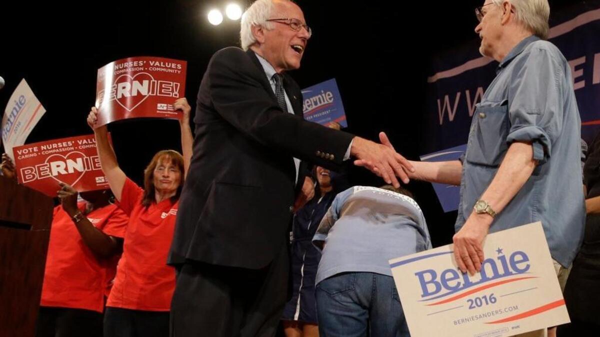 
Sen. Bernie Sanders, I-Vt., greets a supporter as he leaves the stage during a town hall event in New York on Sept. 18.
