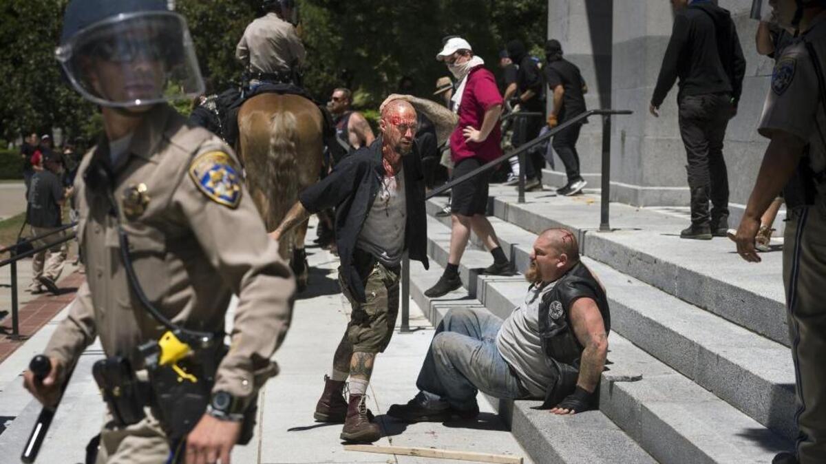 Two men were bloodied when anti-fascist protesters clashed with neo-Nazis who were having a rally at the Capitol on Sunday.