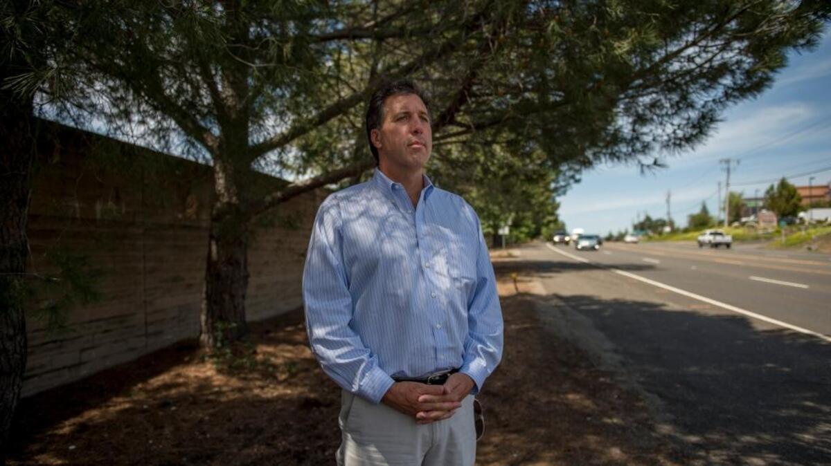 Mark Agosti stands at the site where his son witnessed the death of his two friends struck by a car on this stretch of Highway 49 in Auburn.