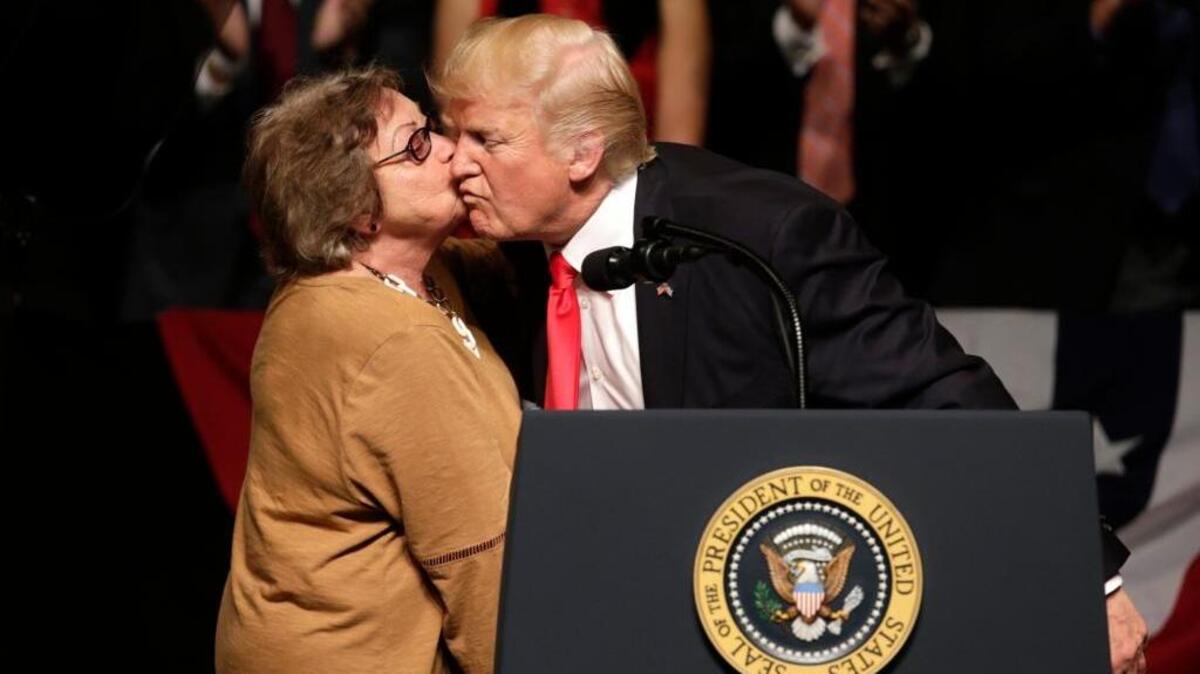 Cuban dissident Cary Roque kisses President Donald Trump as he announced a revised Cuba policy aimed at stopping the flow of U.S. cash to the country’s military.