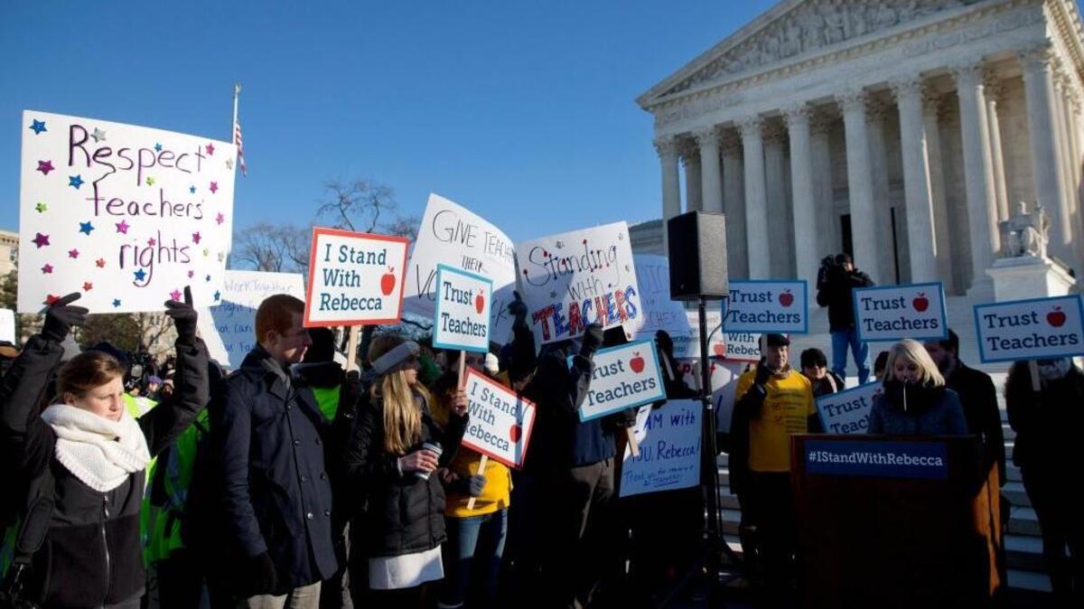 Pro-union demonstrators rally earlier this month outside the U.S. Supreme Court building in Washington, where justices heard arguments in Friedrichs v. California Teachers Association. The case challenges the right of public-sector labor unions to collect dues from workers who choose not to join.