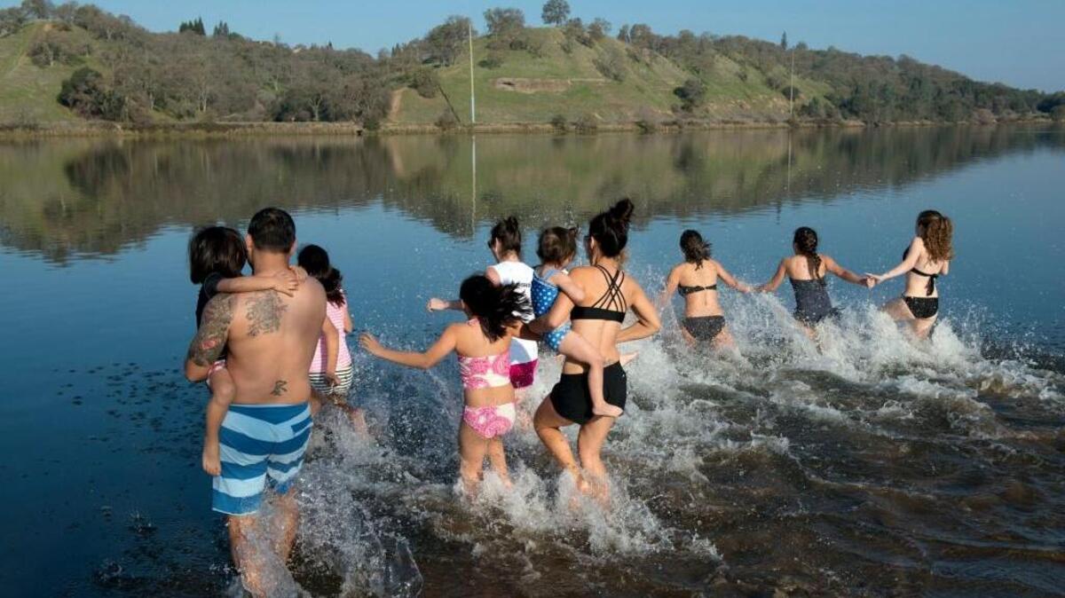 Several groups, including this family and friends from Roseville took to the chilly, 51-degree water at Lake Natoma for a fun Polar Bear Plunge to celebrate the New Year on Jan. 1, 2015.