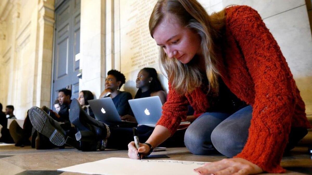 Morgan Harvey, a Princeton University senior from Oregon House, works on a sign while taking part in a sit-in on Nov. 19 with protesters from the Black Justice League, who demanded the school remove the name of former school president and U.S. President Woodrow Wilson from buildings over what they said was his racist legacy.