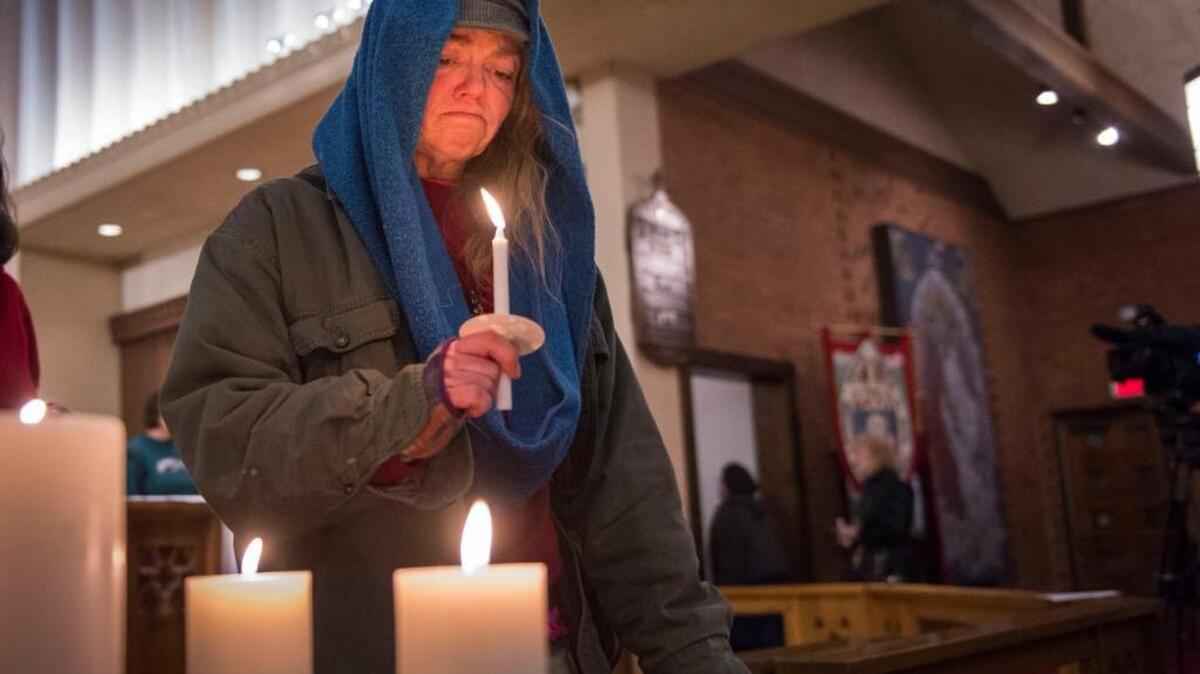 Tara Darnell participates in the Interfaith Homeless Memorial Service held at Trinity Cathedral in December. She lost three friends last year who were living on the street.