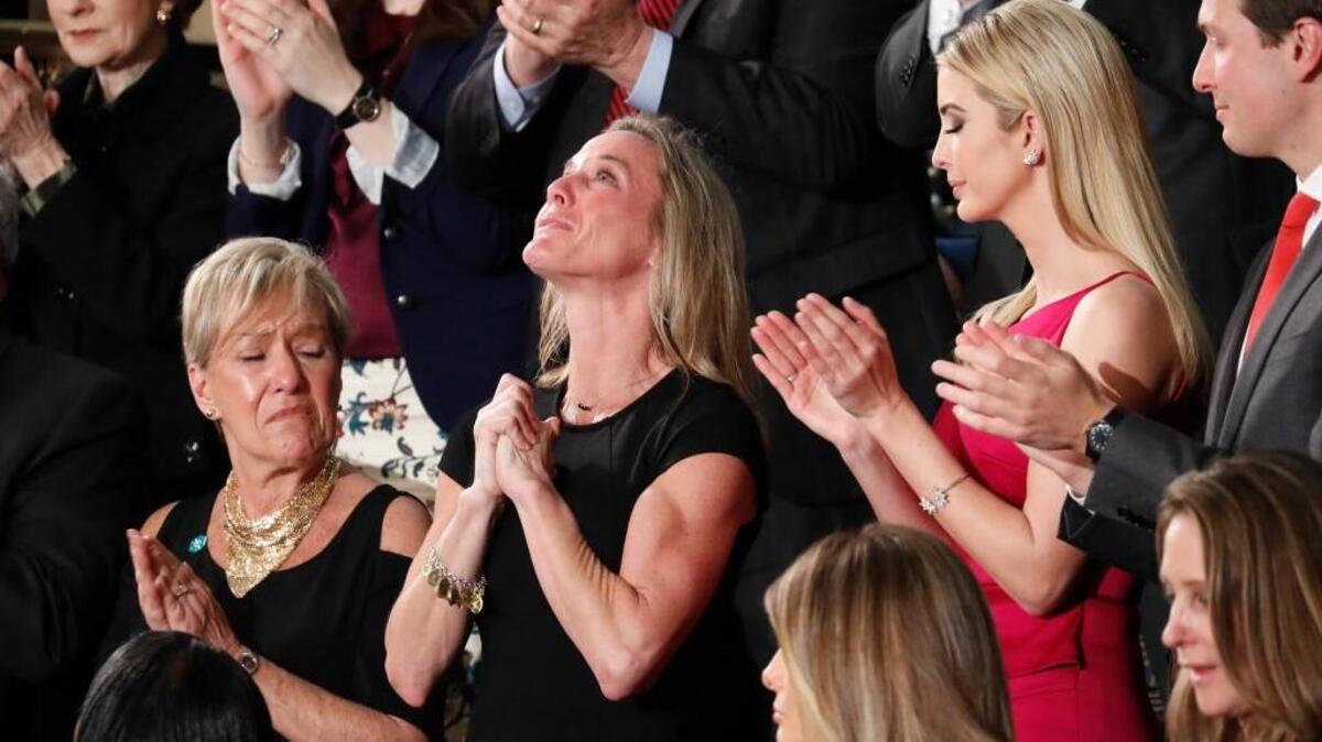 Carryn Owens, widow of widow of Chief Special Warfare Operator Ryan Owens, is applauded after she was acknowledged by President Donald Trump during his address to Congress on Tuesday night.