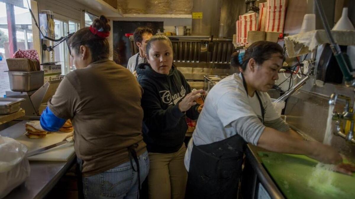Martha Camarena, center, who works at Chando’s on Arden Way, was able to purchase a reliable car when the minimum wage was increased.