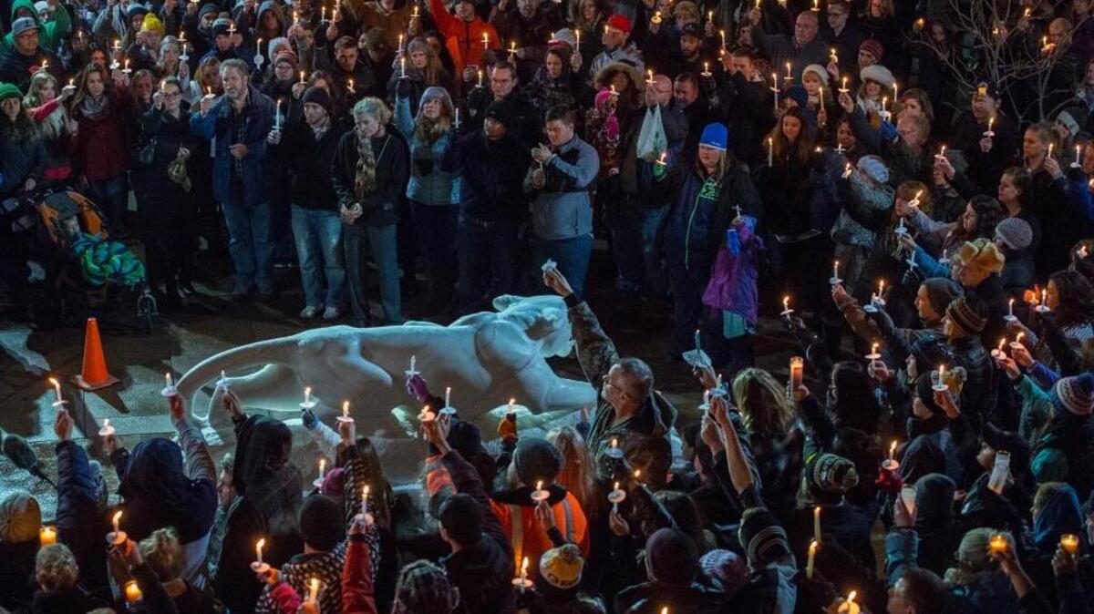 Mourners attend a vigil Saturday on the University of Colorado-Colorado Springs’ campus for those killed in the deadly shooting at a Planned Parenthood clinic. One letter writer thinks the shooting should be described as an act of “extremist Christian domestic terrorism.”