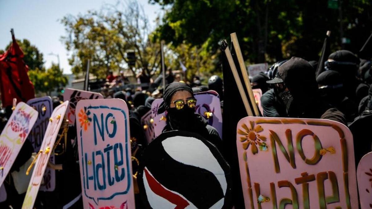 Protesters hold up shields as they anticipate getting pepper sprayed in Berkeley last Sunday.