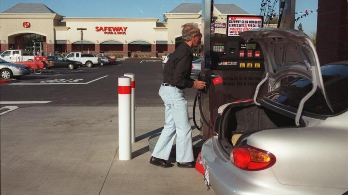 Ken Steege tops off his car at the Safeway gas station in Roseville.