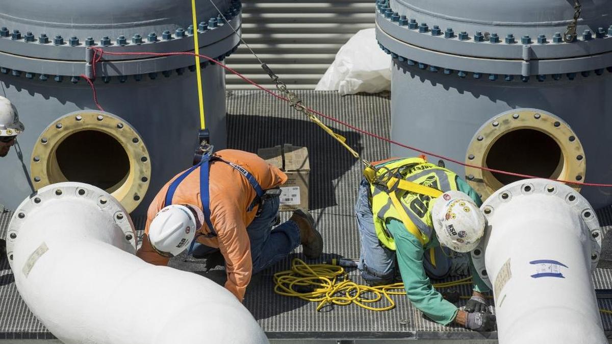 Workers connect pipes at the Carlsbad Desalination Plant in Carlsbad. A letter writer says Orange County does not need water from a Poseidon desalination plant.