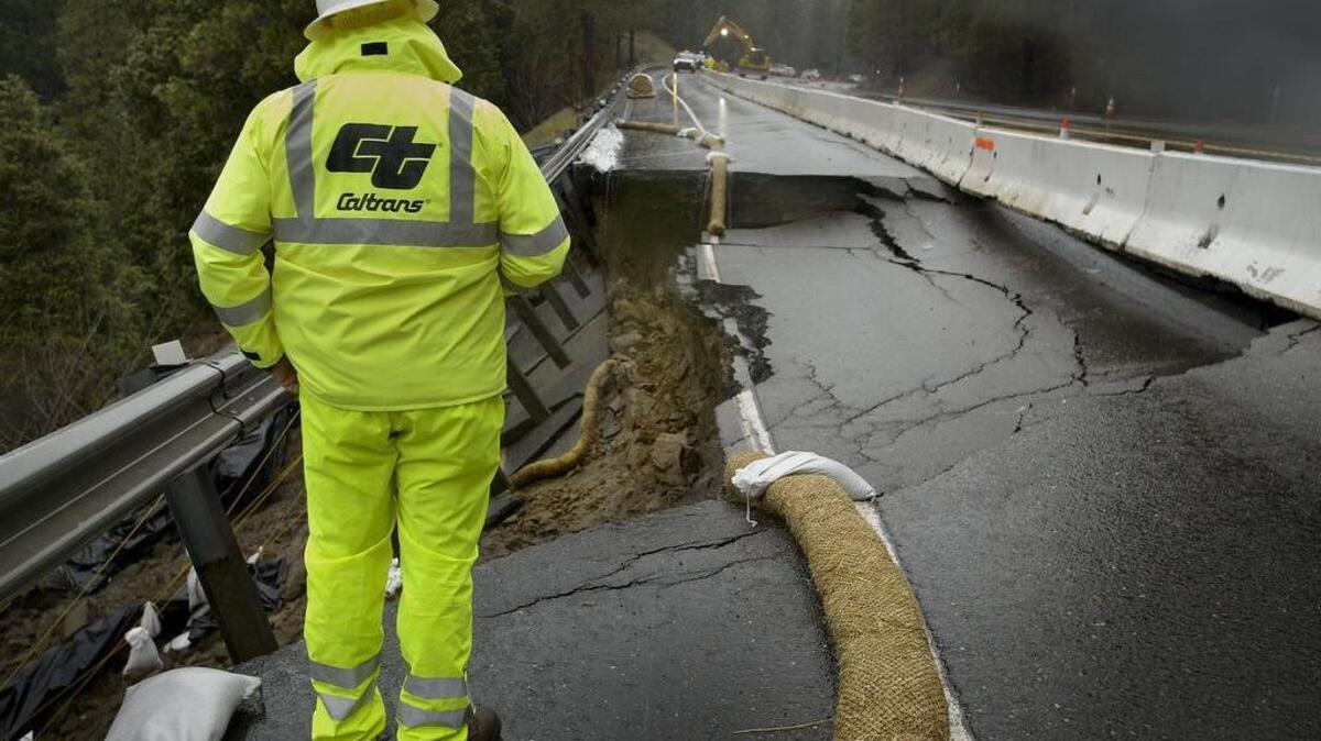 CalTrans engineer Jarrett Woodruff inspects the crumbling section of westbound U.S. 50 in El Dorado County on Feb. 21.