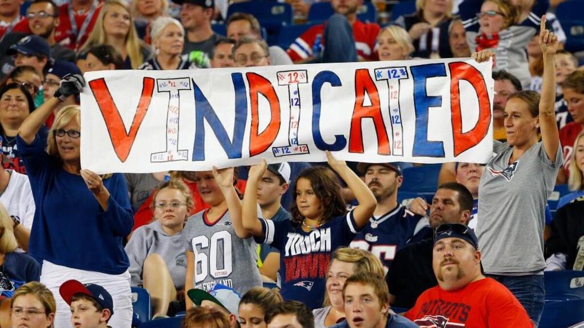 
New England Patriots fans hold a sign that refers to Patriots quarterback Tom Brady in the first half of an NFL football game between the Patriots and the New York Giants on Thursday in Foxborough, Mass. Federal Judge Richard M. Berman overturned NFL Commissioner Roger Goodell’s four-game suspension of Brady on Thursday morning. The league said it will appeal the ruling. 
