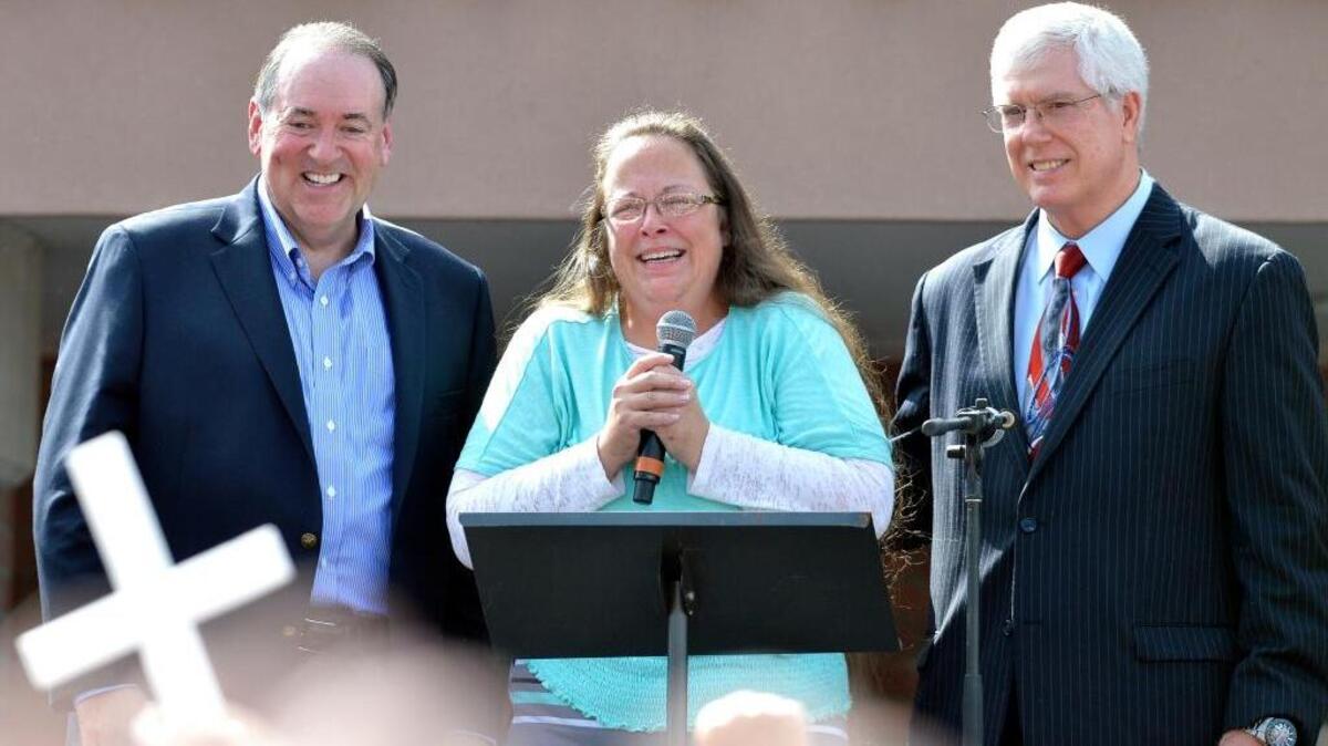 
Rowan County Clerk Kim Davis, center, with Republican presidential candidate Mike Huckabee, left, and attorney Mat Staver, greets the crowd after being released from custody Tuesday.
