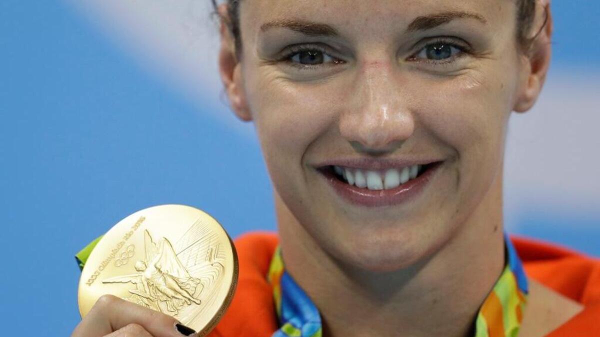 Hungary’s Katinka Hosszu shows off her gold medal for the women’s 200-meter individual medley final during the swimming competitions at the 2016 Summer Olympics, Wednesday, Aug. 10, 2016, in Rio de Janeiro, Brazil.