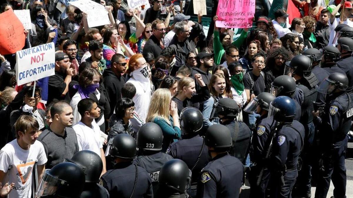 Police officers form a line in front of protesters outside the hotel where Donald Trump was speaking to the California Republican Party convention in Burlingame on Friday.