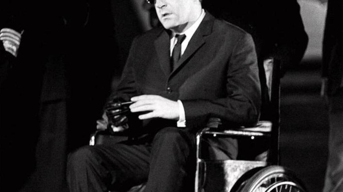 Actor Peter Sellers sits in a wheelchair portraying the titular character during production of the 1964 movie "Dr. Strangelove.”