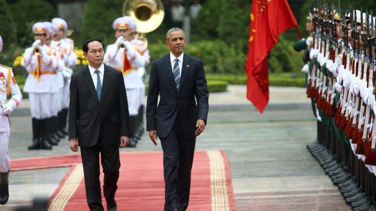 President Barack Obama and Vietnamese President Tran Dai Quang review the honor guard during a welcoming ceremony at the Presidential Palace in Hanoi, Vietnam, on Monday.