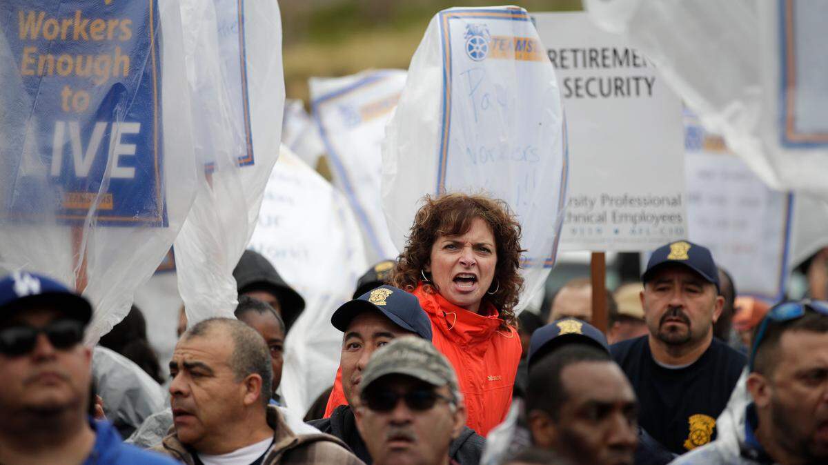 University of California hospital workers gather outside the UCLA Medical Plaza during a protest Tuesday, Jan. 10, 2017, in Los Angeles. More than 11,000 clerical and administrative support workers are on a one-day strike against the 10-campus University of California system and medical centers. (AP Photo/Jae C. Hong)