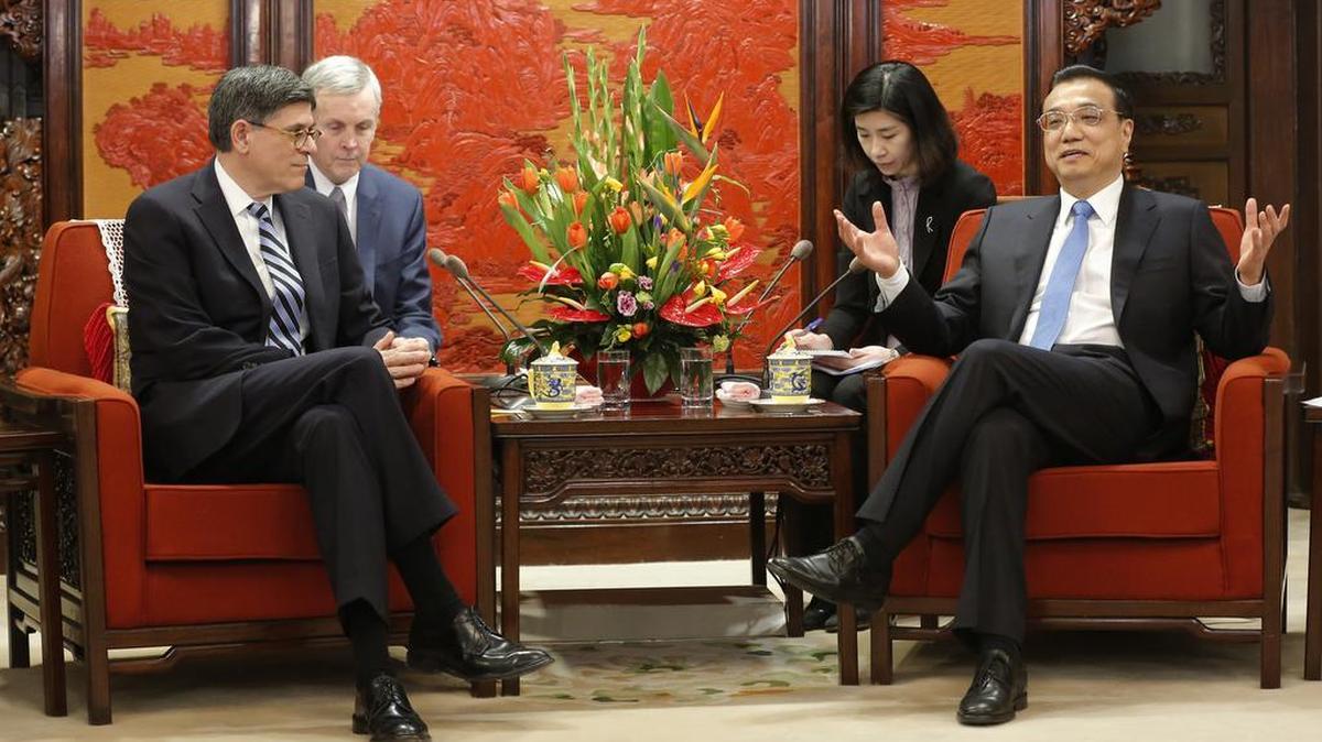 Chinese Premier Li Keqiang, right, talks with U.S. Treasury Secretary Jacob Lew in Beijing on Monday. Chinese citizens and leaders alike are watching Donald Trump closely.