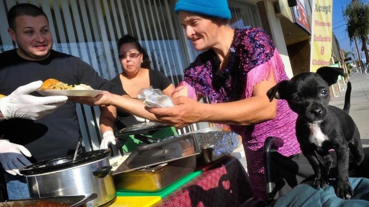 
Crickette Blackwell, who is homeless, is served a Thanksgiving meal by volunteers at Westcare in Fresno last year. Fresno is one of the poorest metro areas in the United States, yet people keep moving there.
