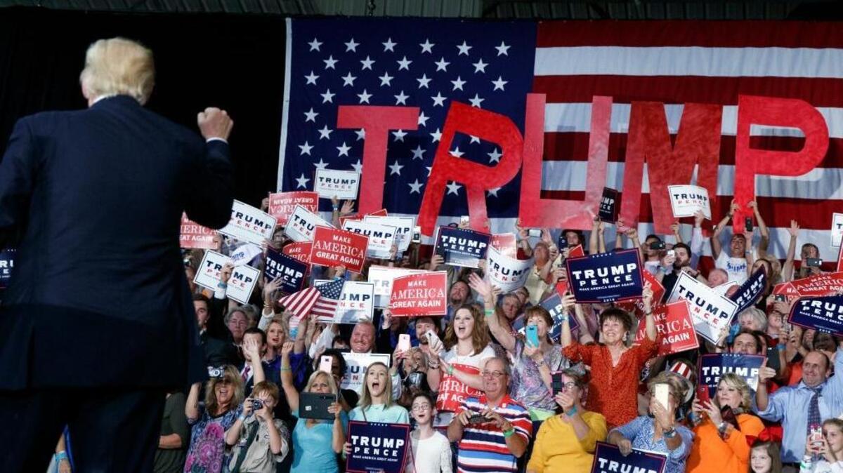 Supporters cheer as Donald Trump arrives at a campaign rally Tuesday in Kenansville, N.C.