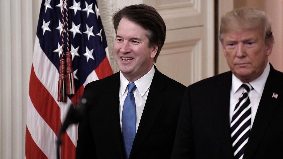 President Donald Trump, right, and Brett Kavanaugh, associate justice of the Supreme Court, arrive at a ceremonial swearing-in at the White House on Oct. 8.