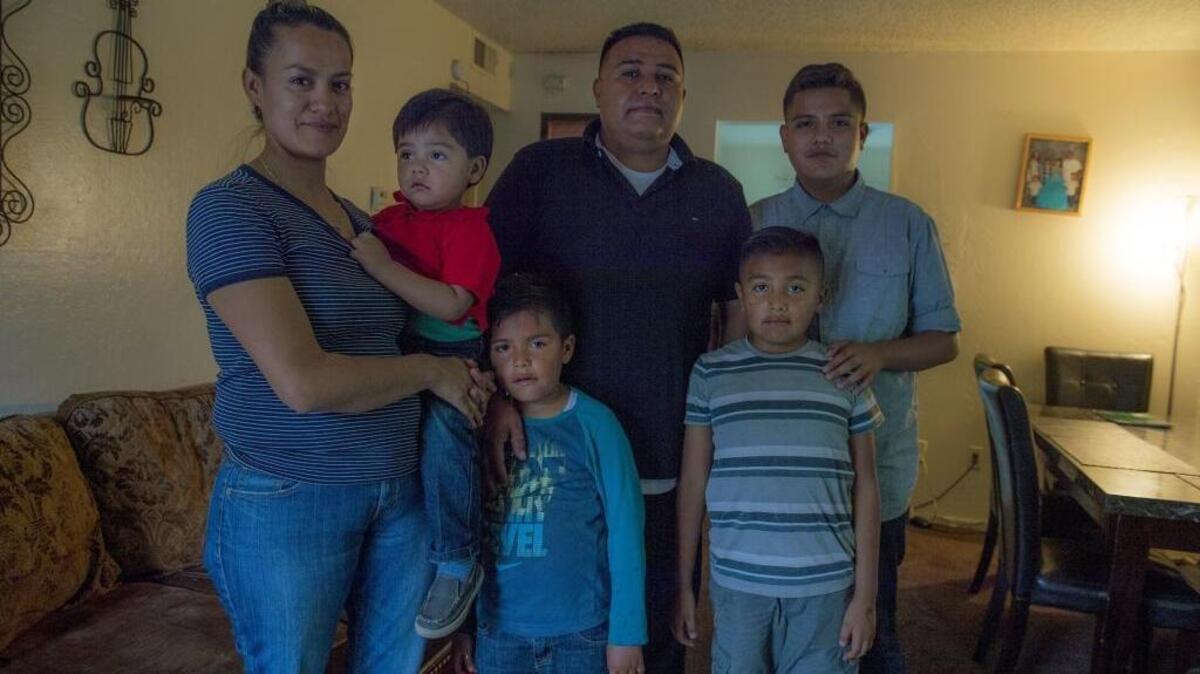 Victor and Gabriela Gonzalez and their four boys pose in their Woodland home in April. One son, Felix, was covered under a Medi-Cal expansion on May 15.