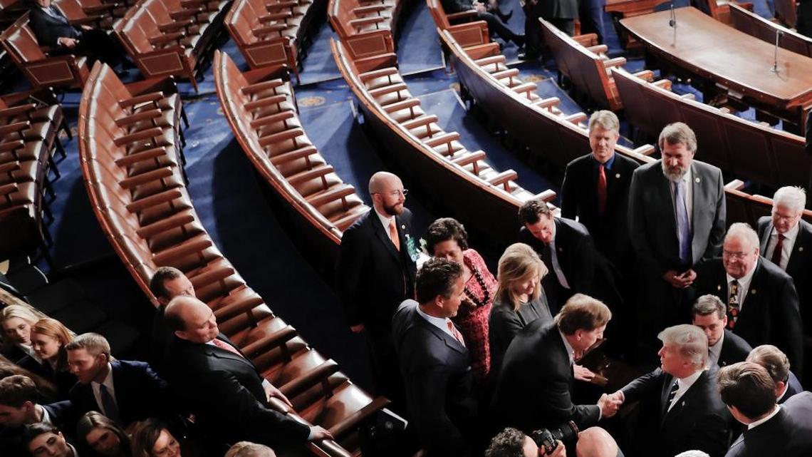 President Donald Trump, lower right, shakes hands as he leaves Capitol Hill in Washington on Feb. 28 following his address to a joint session of Congress. The row of empty seats were for the Democrats who left before Trump had finished walking out. Rep. Ro Khanna says, “Members of Congress must see that the American people want more idealism and substance from progressive politics.”