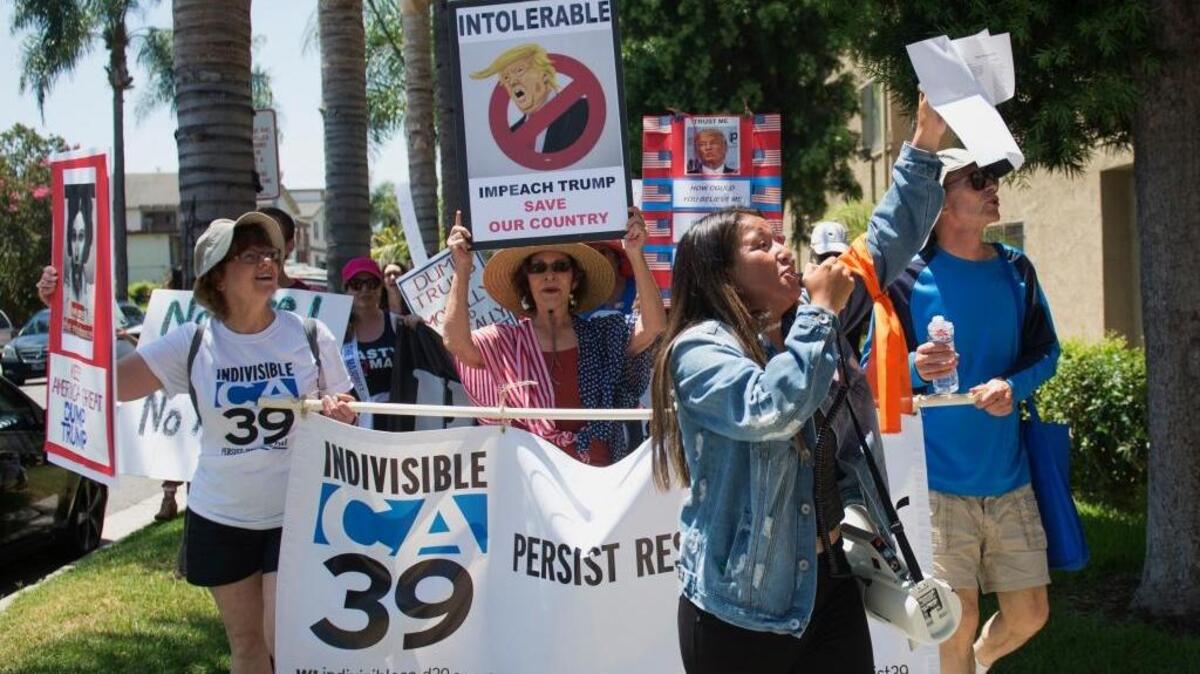 Marchers encourage Congress to impeach President Donald Trump in Santa Ana on Sunday.