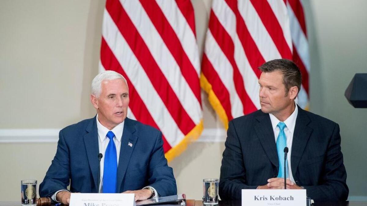 Vice President Mike Pence, left, and Kansas Secretary of State Kris Kobach preside at the first meeting of the Presidential Advisory Commission on Election Integrity on July 19. The White House has dissolved the panel.
