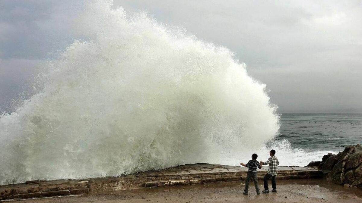 
Visitors watch the waves break last December in Pacific Grove, at one end of Highway 68, which ends in Salinas and shows the growing inequality in California. 
