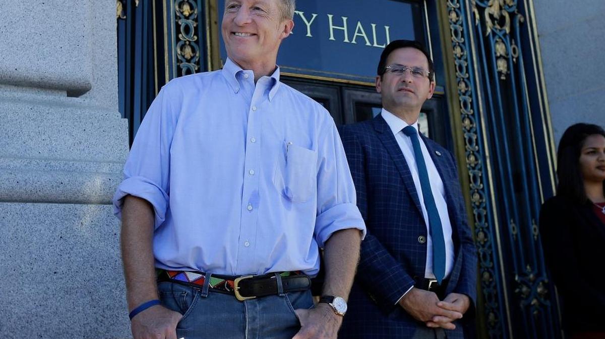 Tom Steyer, left, smiles before speaking at a rally calling for the impeachment of President Donald Trump in San Francisco on Oct. 24.