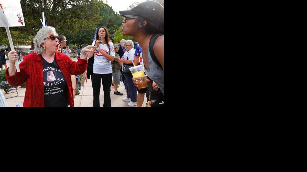 
Carol Schlaepfer, left, from Chino Valley argues with a UC Irvine student earlier this month over the proposal to ban the American flag from a university lobby.
