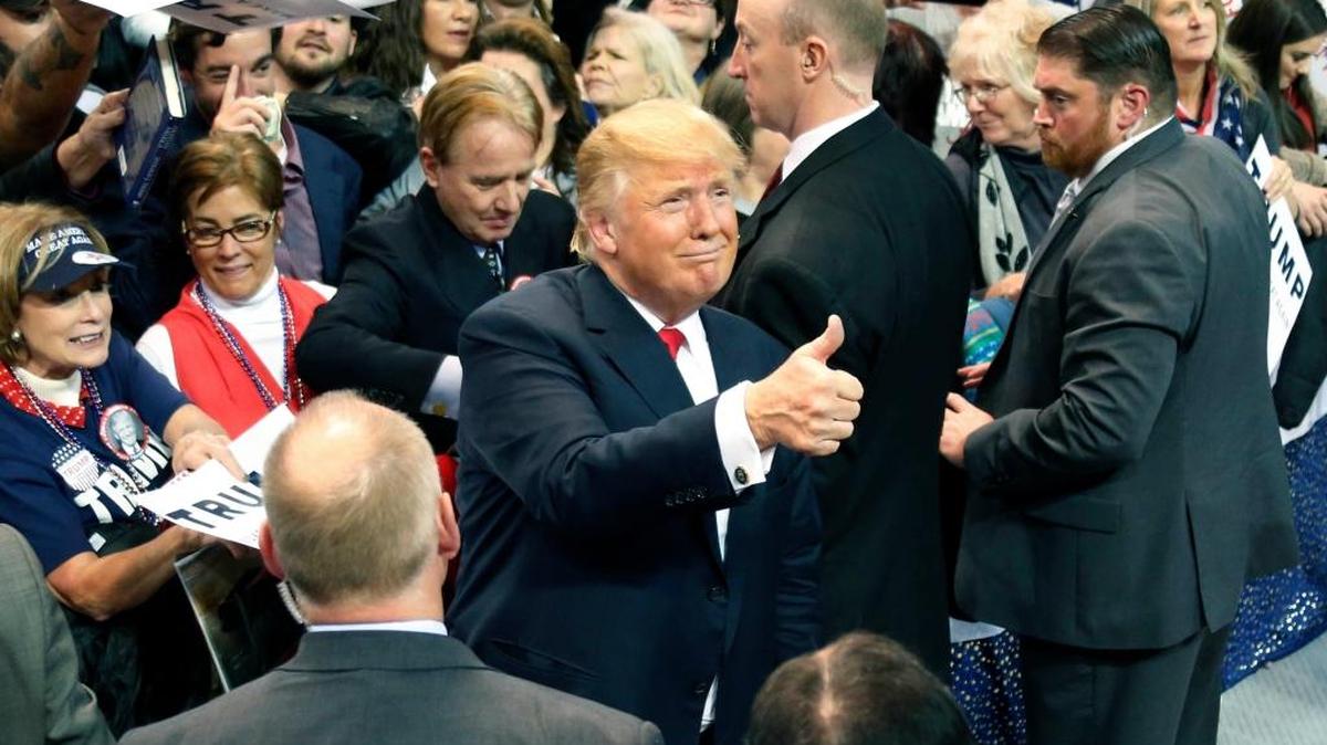 Surrounded by supporters and security, Republican presidential candidate Donald Trump gives a thumbs up at a rally Saturday in Biloxi, Miss.