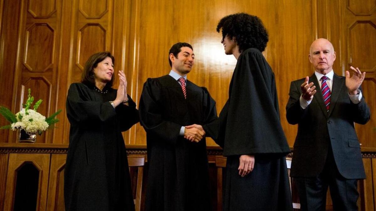 New state Supreme Court Justice Leondra Kruger, second from right, is congratulated as Gov. Jerry Brown, far right, applauds in January 2015. Brown has another vacancy to fill, but is in no hurry.