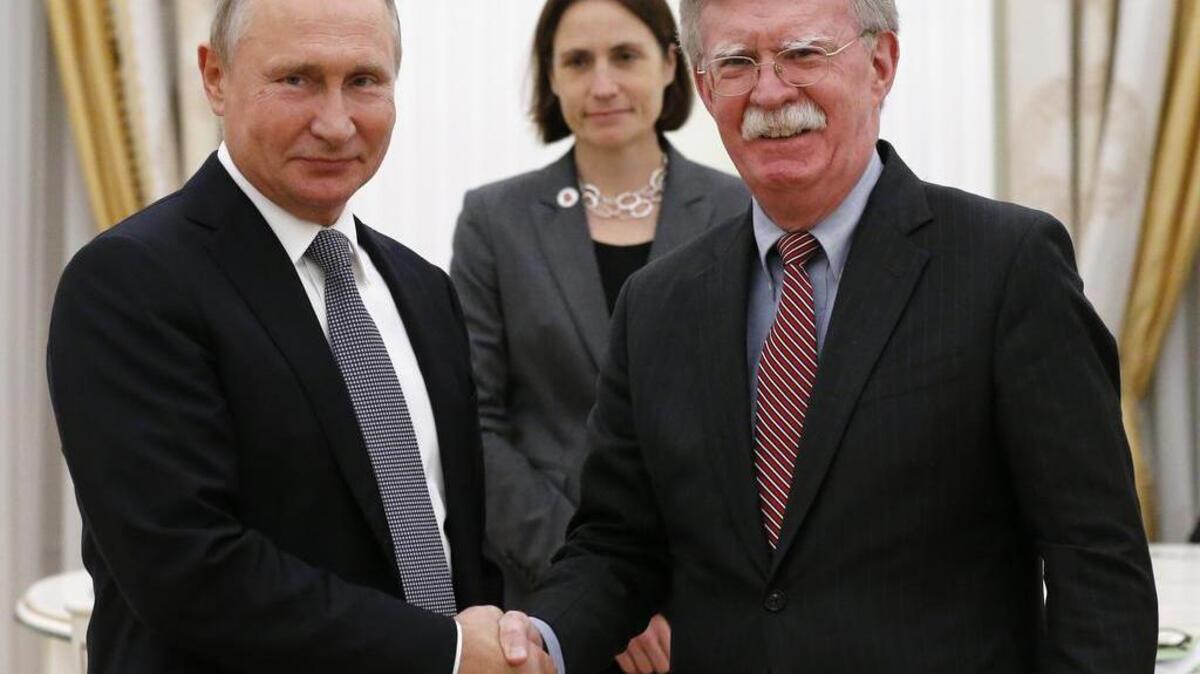 Russian President Vladimir Putin, left, shakes hands with U.S. national security adviser John Bolton during their meeting in the Kremlin on Tuesday.