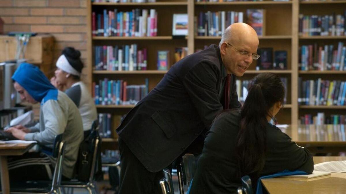 Teacher Larry Ferlazzo works with a student in January at Luther Burbank High School in Sacramento, which pairs student teachers with veteran teachers.