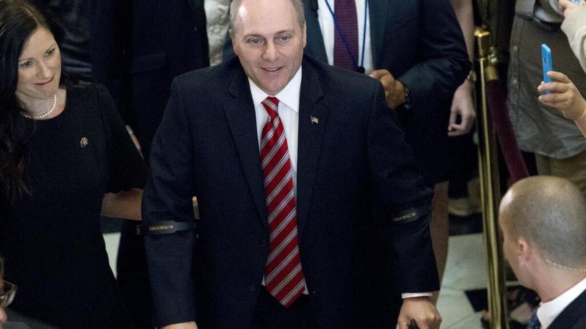 House Republican Whip Steve Scalise walks with his wife Jennifer as he leaves the House chamber on Sept. 28, 2017. To hugs and a bipartisan standing ovation, Scalise returned to the House, more than three months after he was shot at a congressional baseball practice.