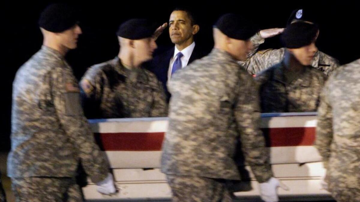 Then-President Barack Obama, center, salutes as an Army team carries the coffin containing the remains of Sgt. Dale R. Griffin of Terre Haute, Ind., at Dover Air Force Base, Del., on Oct. 29, 2009. President Donald Trump is claiming his predecessors did not sufficiently honor the nation’s fallen.