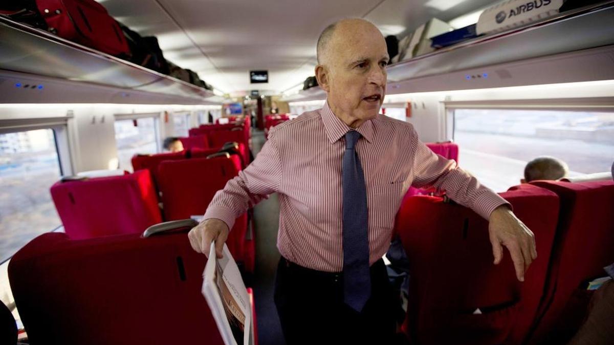 California Gov. Jerry Brown speaks to journalists on board a high speed rail leaving from the Beijing South train station during his last trip to China in 2013.