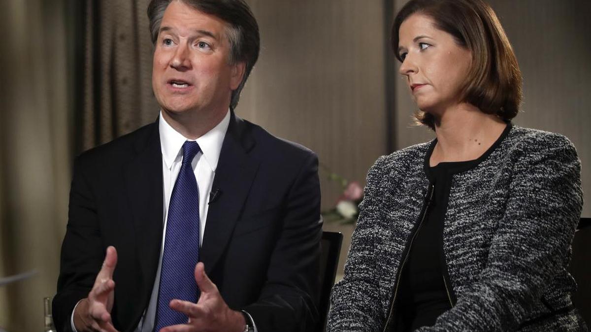 Brett Kavanaugh, with his wife Ashley Estes Kavanaugh, answers questions about sexual assault allegations during a Fox News interview on Monday.