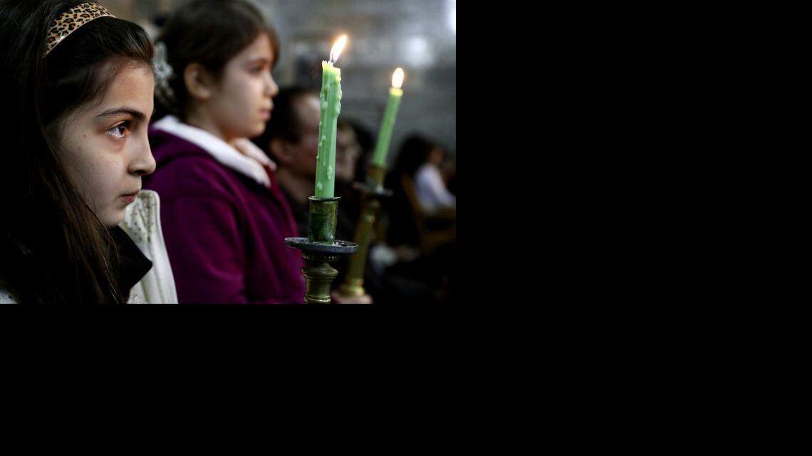 
Iraqi Christians celebrate Christmas Eve mass in the Chaldean Church of the Virgin Mary in al-Qoush in northern Iraq.
