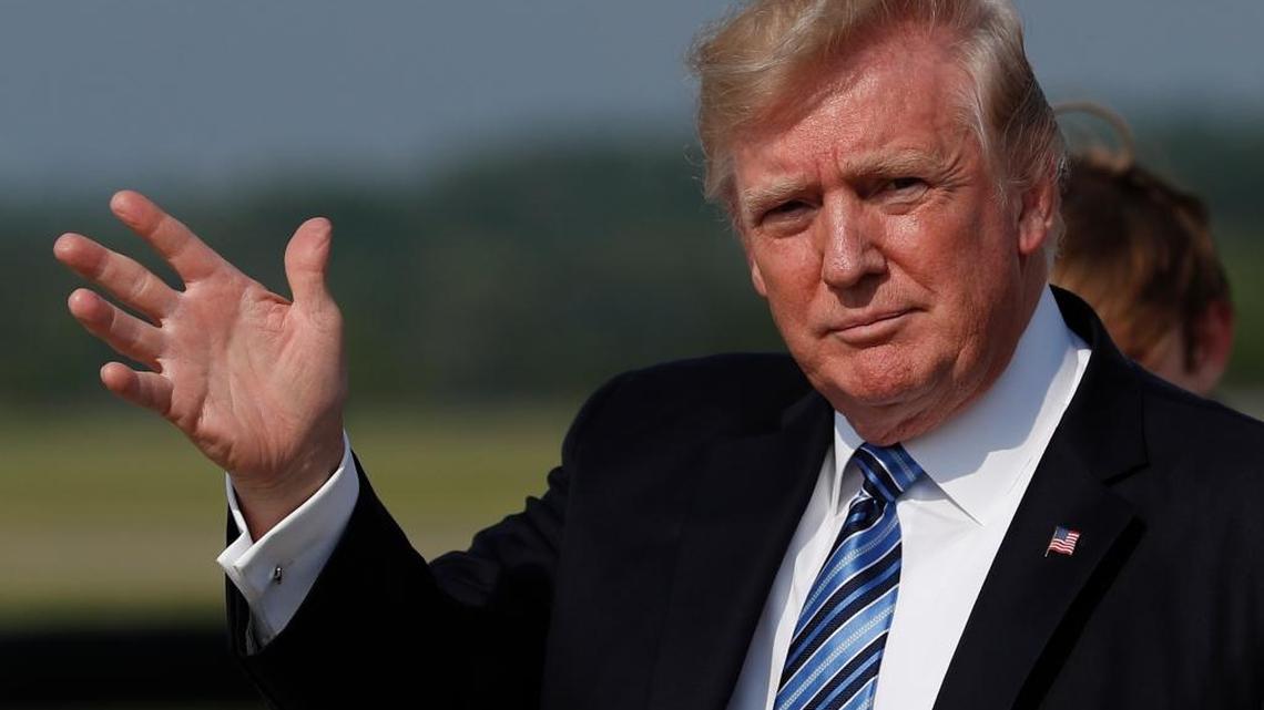 In this June 30, 2017, photo, President Donald Trump waves as he arrive on Air Force One .