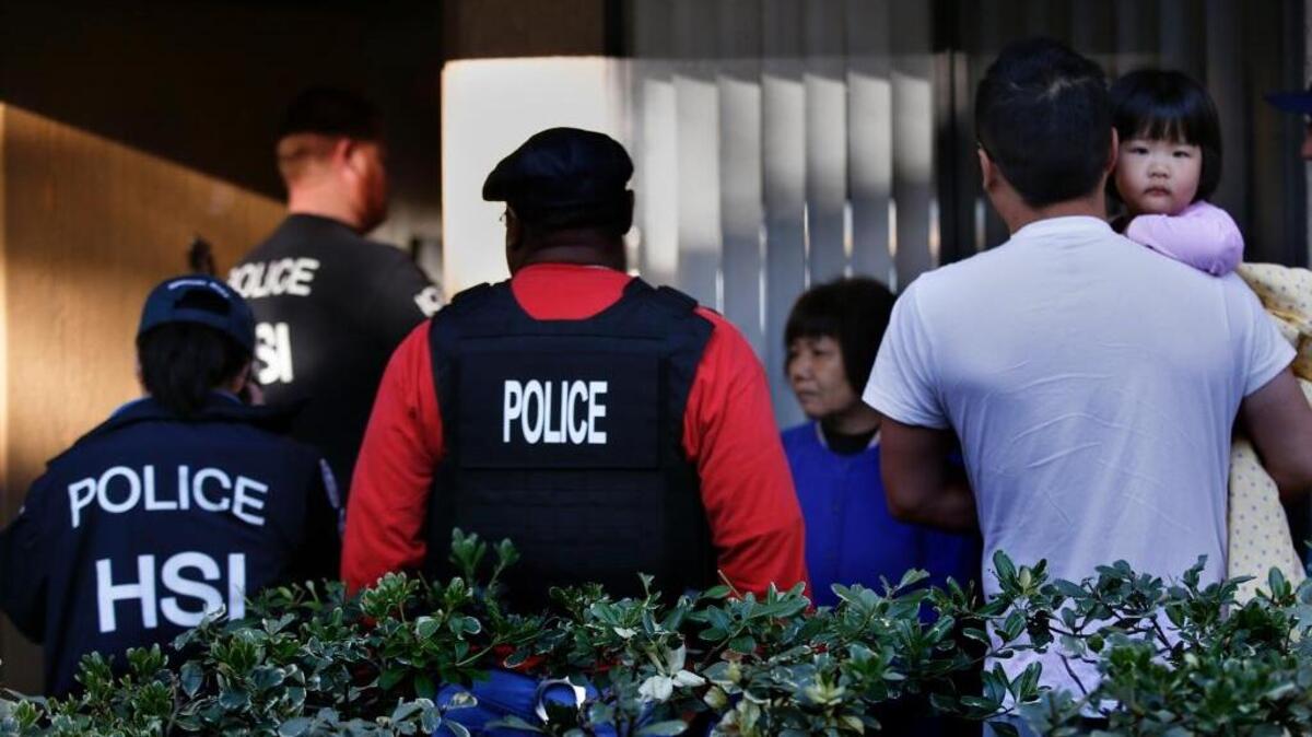 
Federal agents serve warrants and question residents at an apartment complex in Rowland Heights in March while investigating alleged “birth tourism.” 
