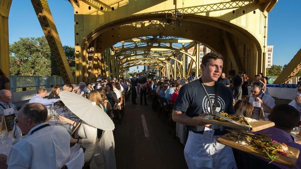 Dr. Viva Ettin shades herself with an umbrella during the Farm-to-Fork Dinner at Tower Bridge in September. It was at one of these events that Sandy Smoley of RePower the Tower came up with the idea of improving the bridge’s lighting.
