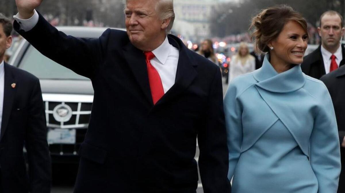 President Donald Trump and first lady Melania Trump walk in the inauguration parade on Pennsylvania Avenue on Friday.
