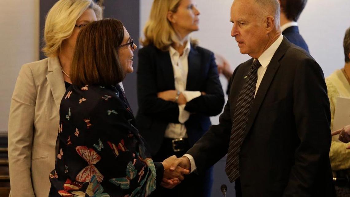 Gov. Jerry Brown, right, shakes hands with Oregon Gov. Kate Brown before a ministerial meeting on clean energy on June 1 in San Francisco.